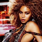 Beyonce with dark hair in afro style