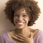 Smiling woman with brown natural curls